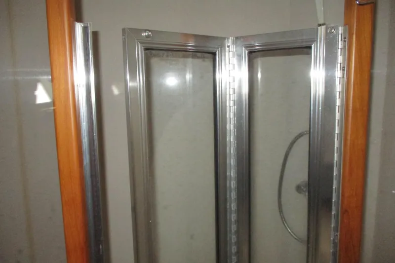 Slide: The Image of Shower door with metal frame on 1997 Mainship 350 Trawler boat. - 42