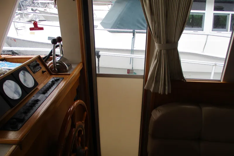 Slide: The Image of Interior view of 1997 Mainship 350 Trawler helm with gauges and controls. - 45