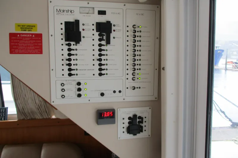 Slide: The Image of Electrical control panel on a 1997 Mainship 350 Trawler boat, featuring various switches and indicators. - 48