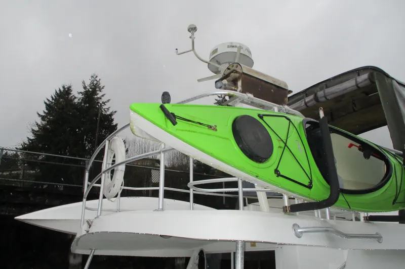 Slide: The Image of Green kayak on 1997 Mainship 350 Trawler deck, overcast sky background. - 57