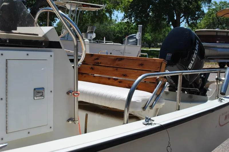 Slide: The Image of 1992 Boston Whaler 17 Montauk boat with Suzuki outboard motor and wooden seating. - 16