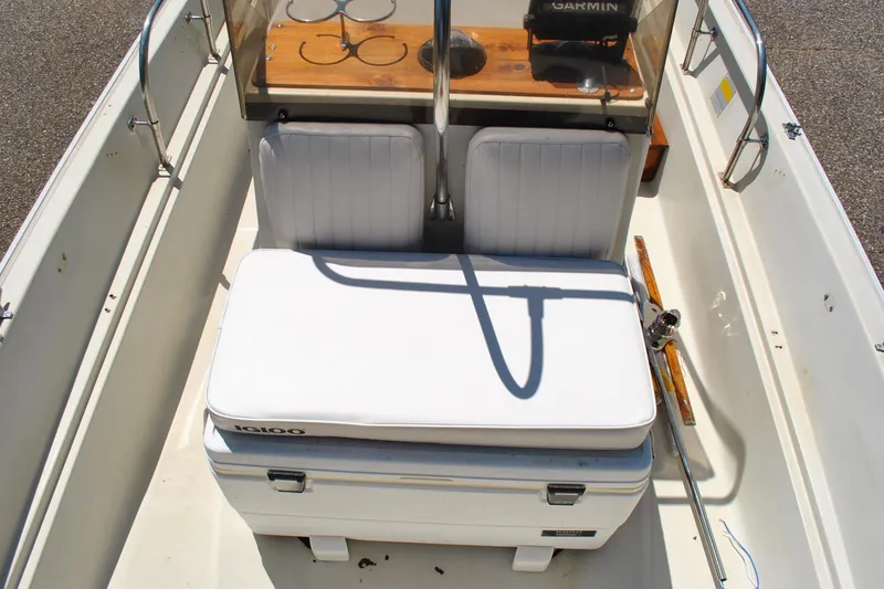 Slide: The Image of 1992 Boston Whaler 17 Montauk interior with seating and cooler, showcasing classic design. - 19