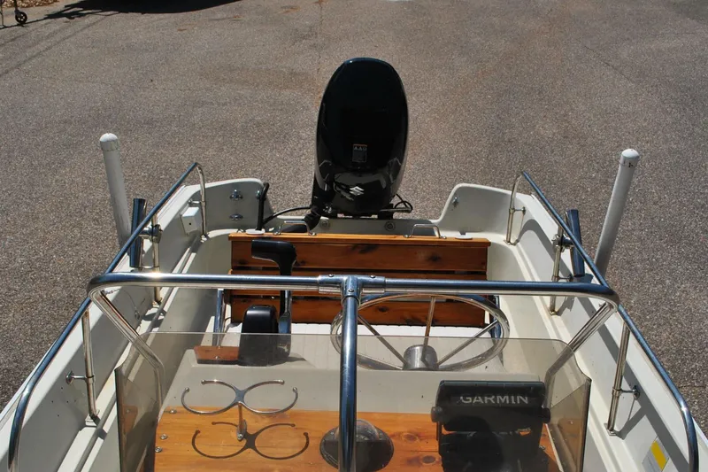 Slide: The Image of 1992 Boston Whaler 17 Montauk boat interior with steering wheel and Garmin equipment. - 20