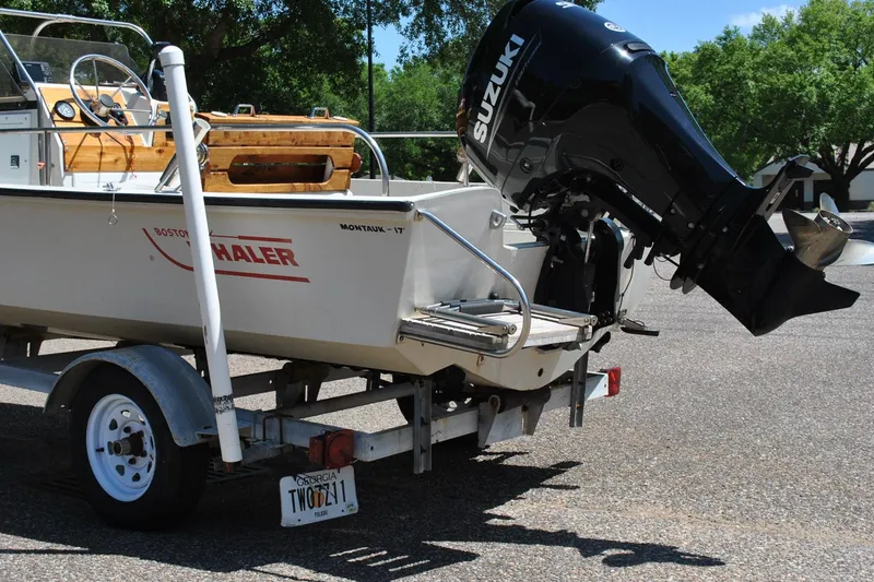 Slide: The Image of 1992 Boston Whaler 17 Montauk boat on trailer with Suzuki outboard motor. - 22