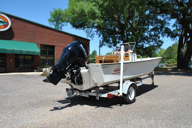 Slide: The Image of 1992 Boston Whaler 17 Montauk boat on trailer, parked outdoors near a brick building. - 6