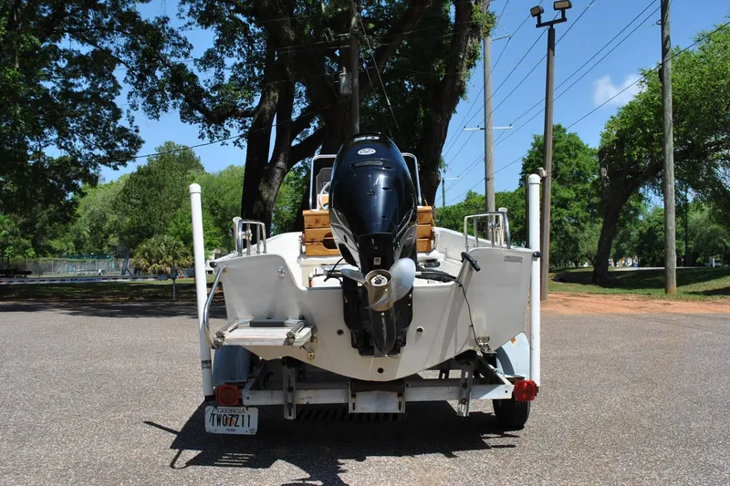 Slide: The Image of 1992 Boston Whaler 17 Montauk boat on trailer, rear view with outboard motor. - 7