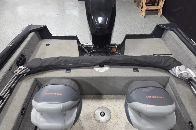 Slide: The Image of Interior of 2010 Tracker Targa V-18 WT boat with seating and covered equipment. - 11