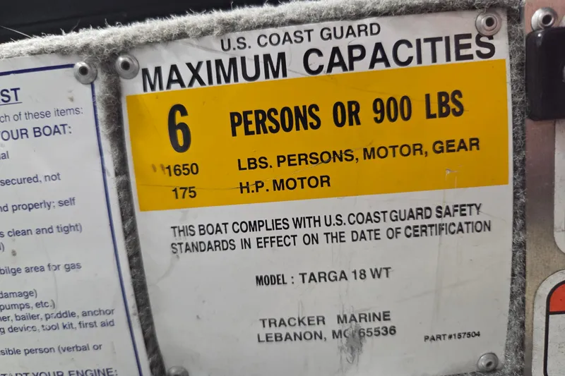 Slide: The Image of 2010 Tracker Targa V-18 WT capacity plate, 6 persons or 900 lbs, U.S. Coast Guard compliant. - 12