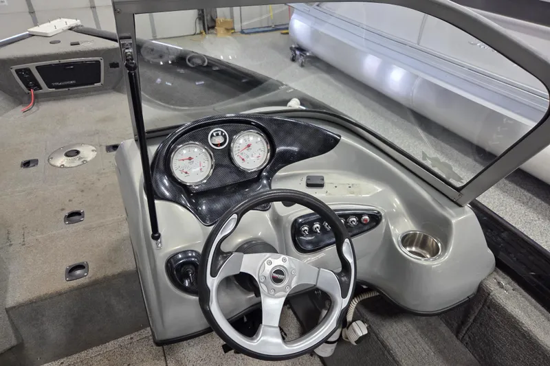 Slide: The Image of 2010 Tracker Targa V-18 WT boat dashboard with steering wheel and gauges. - 7