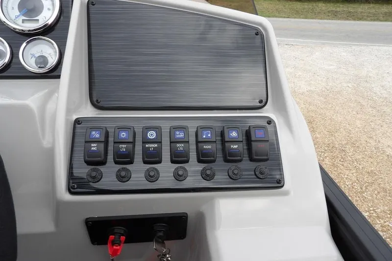 Slide: The Image of Control panel of 2026 Sylvan X5 CLZ boat with various switches and gauges. - 22