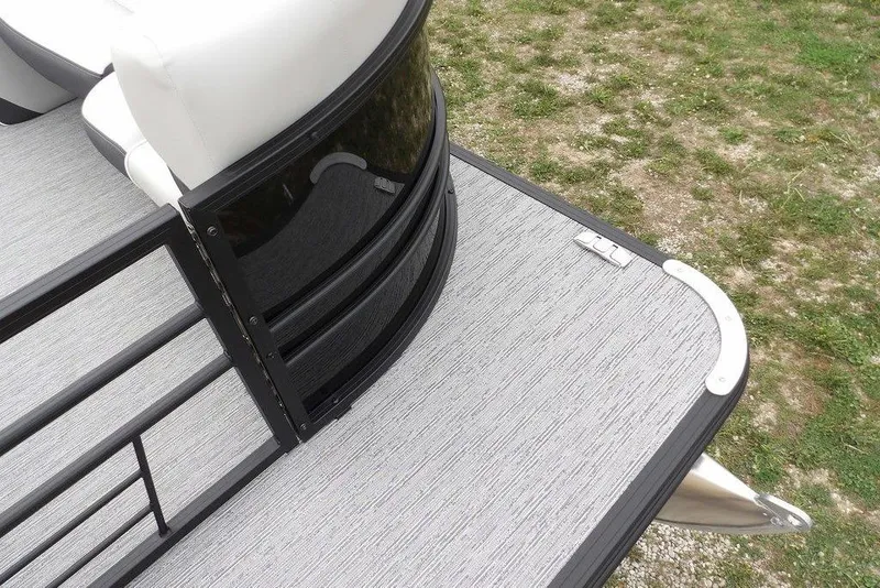 Slide: The Image of Pontoon deck of 2026 Sylvan X5 CLZ with sleek black railing and white seating. - 7