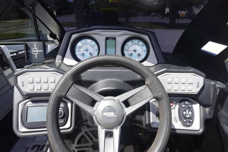 Slide: The Image of 2019 Axis T23 boat dashboard with steering wheel, gauges, and control panels. - 11
