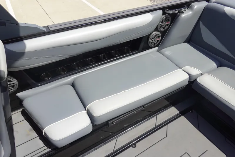 Slide: The Image of 2019 Axis T23 boat interior with gray seating and built-in speakers. - 13