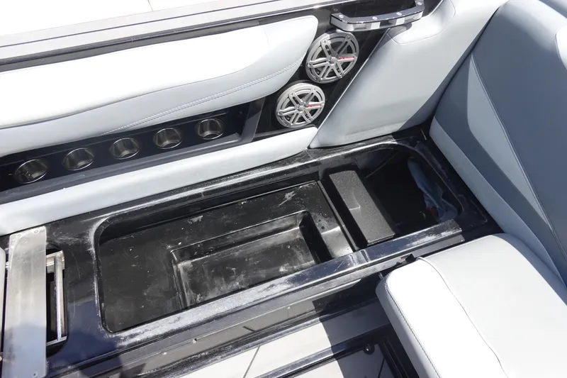 Slide: The Image of Interior of 2019 Axis T23 boat showing storage compartment and speaker system. - 14