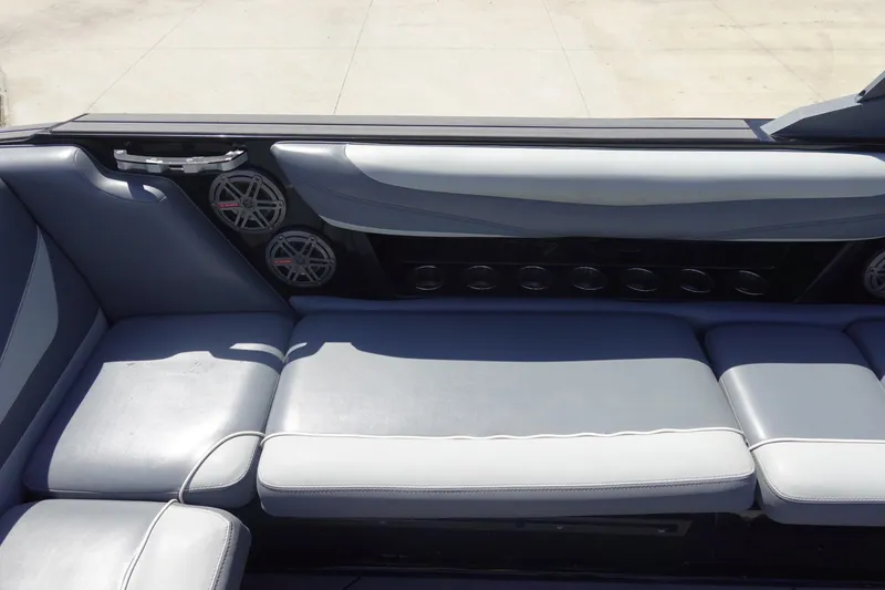 Slide: The Image of 2019 Axis T23 boat interior with gray seating and built-in speakers. - 15