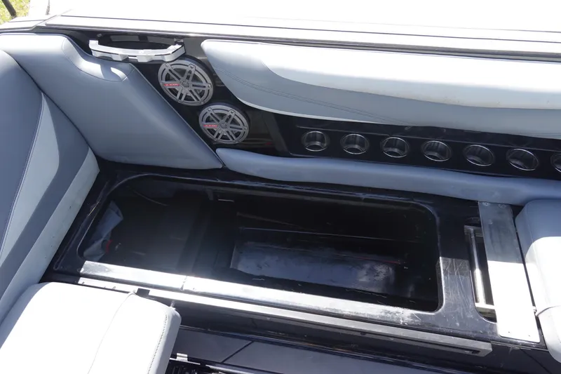 Slide: The Image of Interior of a 2019 Axis T23 boat featuring speakers and cup holders. - 16