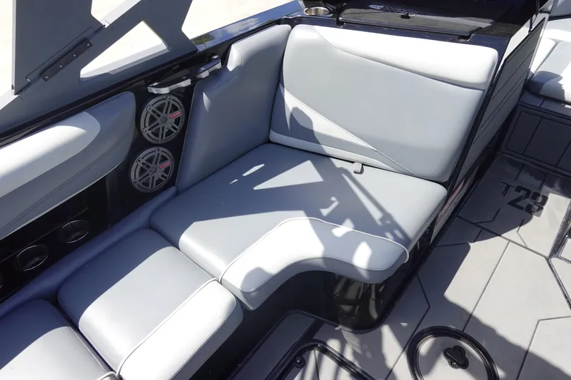 Slide: The Image of 2019 Axis T23 boat interior with gray seating and built-in speakers. - 17