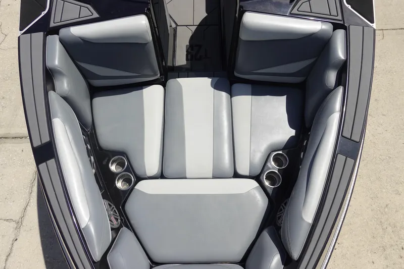Slide: The Image of 2019 Axis T23 boat interior with gray seating and cup holders, top view. - 21