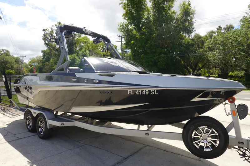 Slide: The Image of 2019 Axis T23 boat on trailer, sleek design, parked outdoors, sunny day. - 4