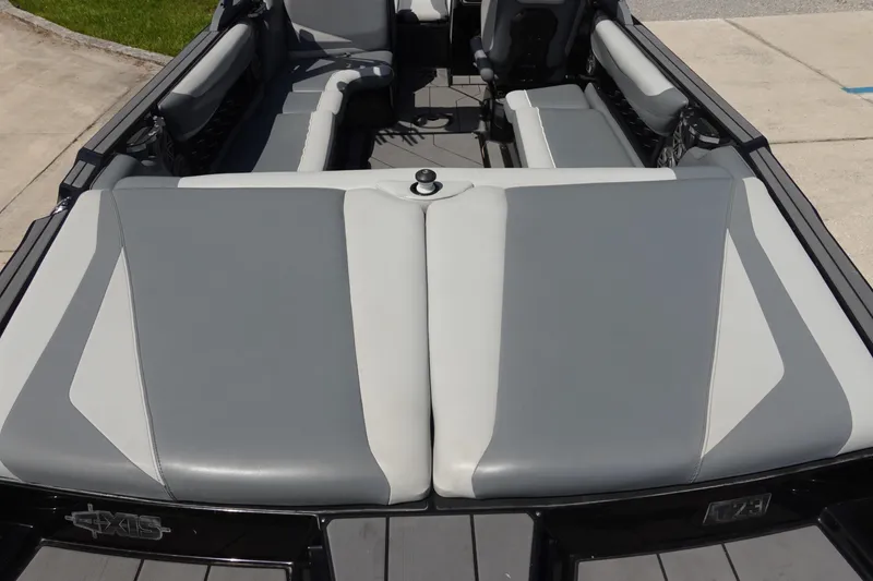 Slide: The Image of 2019 Axis T23 boat interior with gray and white seating, showcasing spacious design. - 7
