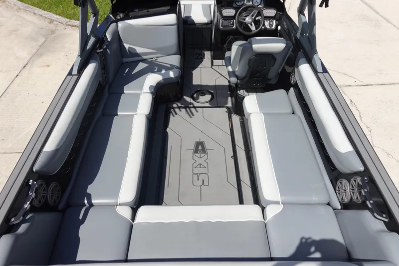 Slide: The Image of 2019 Axis T23 boat interior with gray seating and modern dashboard. - 8