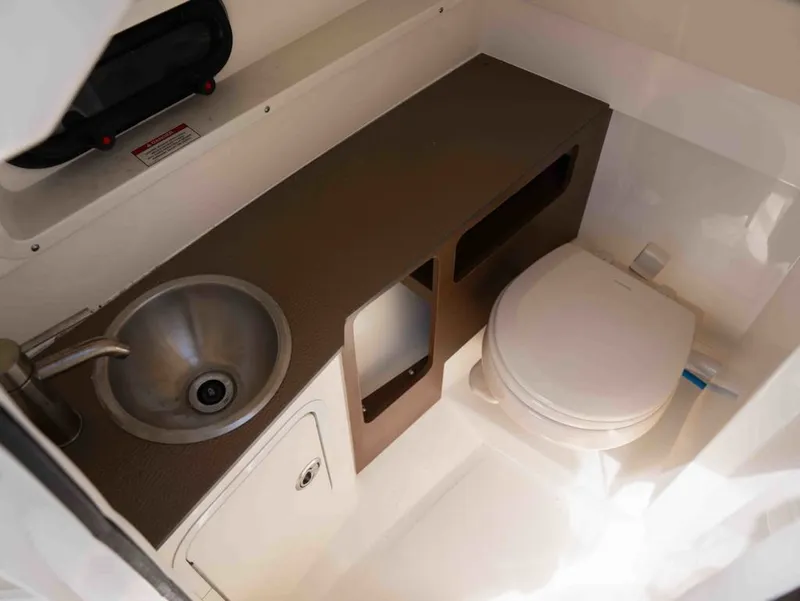 Slide: The Image of Interior of 2018 Sea Ray SDX 270 with sink and toilet. - 25