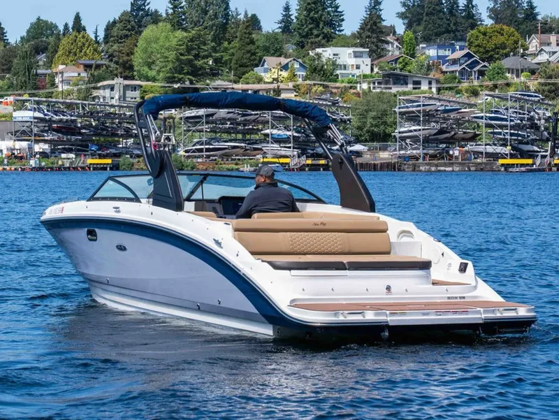 Slide: The Image of 2018 Sea Ray SDX 270 boat cruising on a serene lake. - 4