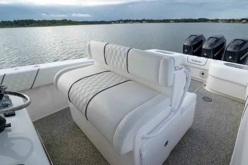 Slide: The Image of 2012 SeaHunter 37 Tournament boat interior with plush seating and multiple outboard engines. - 4