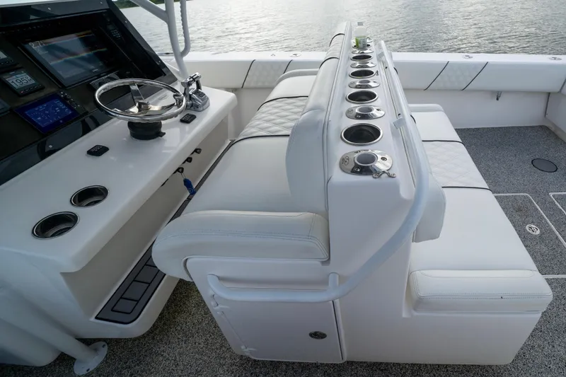 Slide: The Image of 2012 SeaHunter 37 Tournament boat cockpit with steering wheel and seating, overlooking water. - 5