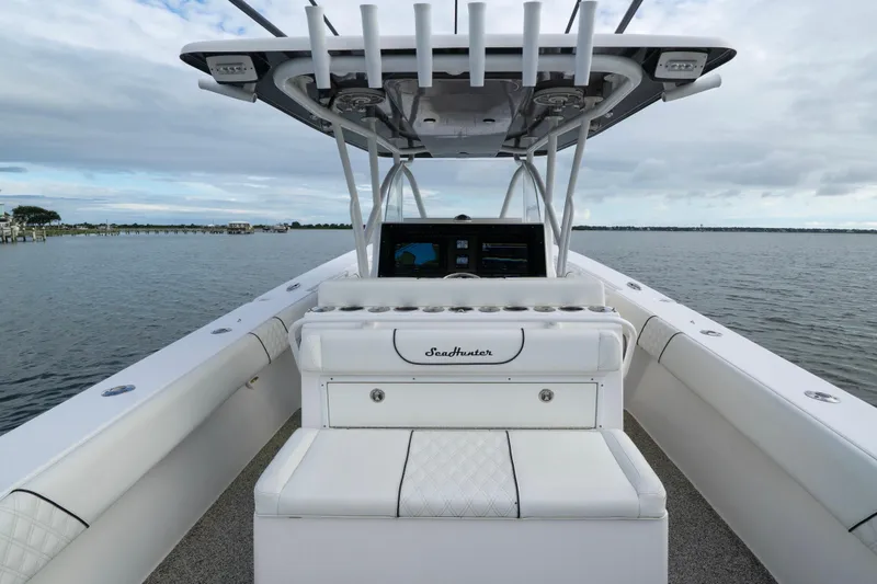 Slide: The Image of 2012 SeaHunter 37 Tournament boat interior with helm, white seating, and ocean view. - 8