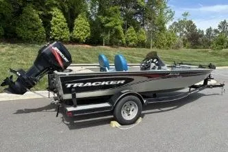 Slide: The Image of 2005 Tracker Tournament V-18 All Fish boat on trailer, parked outdoors. - 12