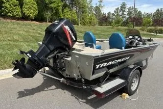 Slide: The Image of 2005 Tracker Tournament V-18 All Fish boat on trailer, featuring Mercury outboard motor. - 13