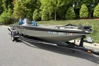 Slide: The Image of 2005 Tracker Tournament V-18 All Fish boat on trailer, parked on a road. - 14