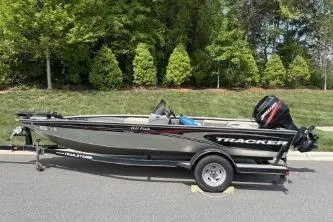 Slide: The Image of 2005 Tracker Tournament V-18 All Fish boat on trailer, parked outdoors. - 16