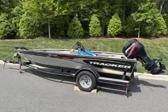 Slide: The Image of 2005 Tracker Tournament V-18 All Fish boat on trailer, parked outdoors. - 17