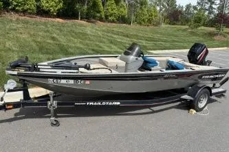 Slide: The Image of 2005 Tracker Tournament V-18 All Fish boat on trailer, parked outdoors. - 18