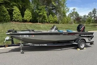 Slide: The Image of 2005 Tracker Tournament V-18 All Fish boat on trailer, parked outdoors. - 19