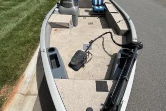 Slide: The Image of 2005 Tracker Tournament V-18 All Fish boat with seating and equipment on a paved surface. - 6