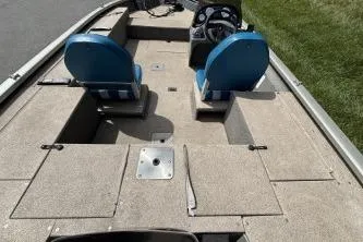 Slide: The Image of 2005 Tracker Tournament V-18 All Fish boat interior with blue seats and storage compartments. - 9