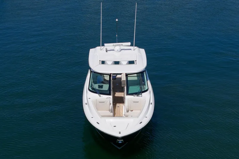 Slide: The Image of 2026 Tiara Yachts 34 LX on calm water, aerial view showcasing sleek design. - 10