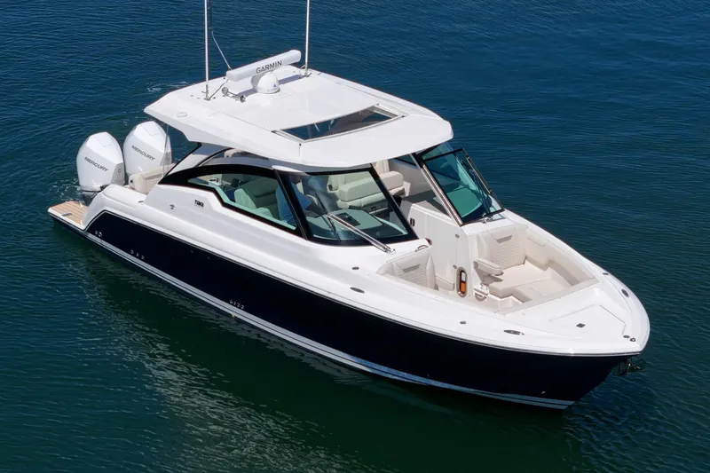 Slide: The Image of 2026 Tiara Yachts 34 LX luxury boat on calm blue water. - 11