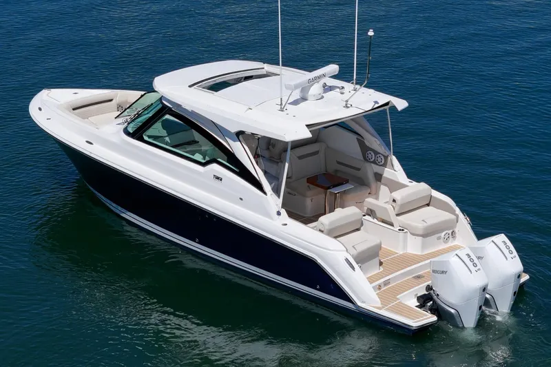 Slide: The Image of 2026 Tiara Yachts 34 LX luxury boat on calm blue water. - 12