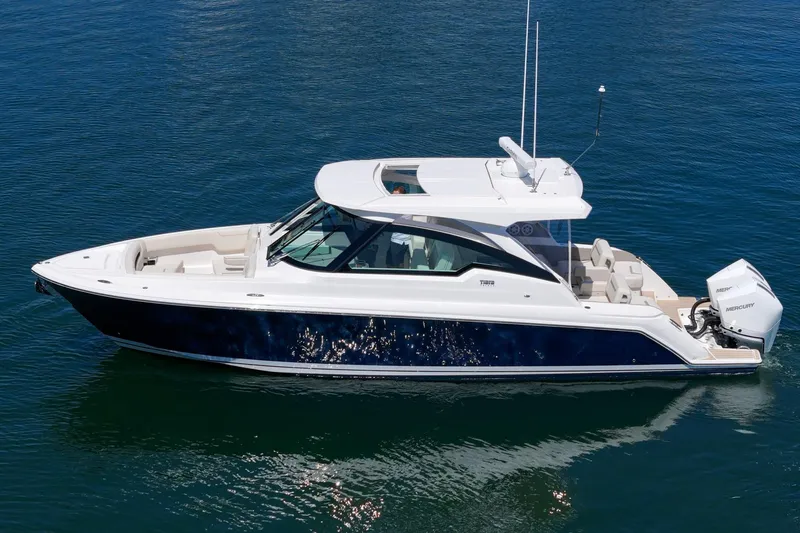 Slide: The Image of 2026 Tiara Yachts 34 LX luxury boat on calm blue water. - 14