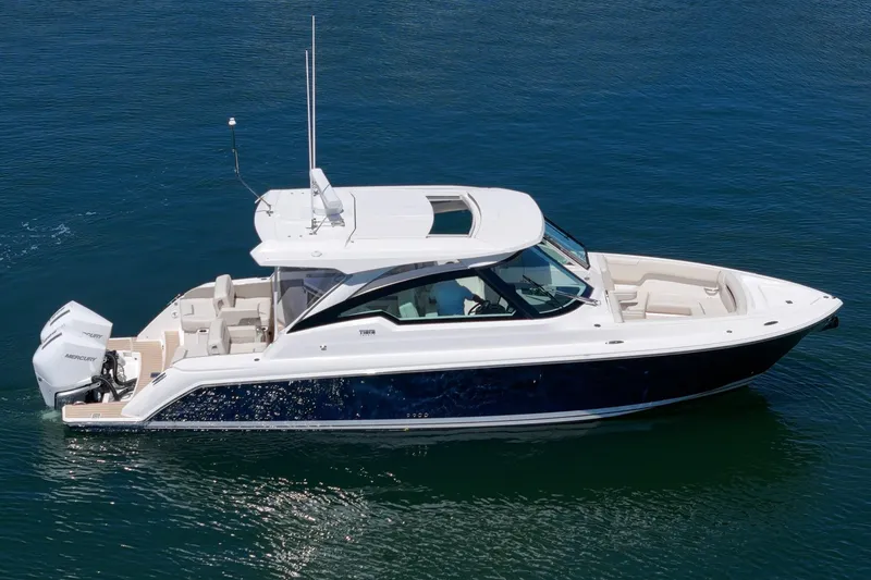 Slide: The Image of 2026 Tiara Yachts 34 LX cruising on calm blue waters. - 15