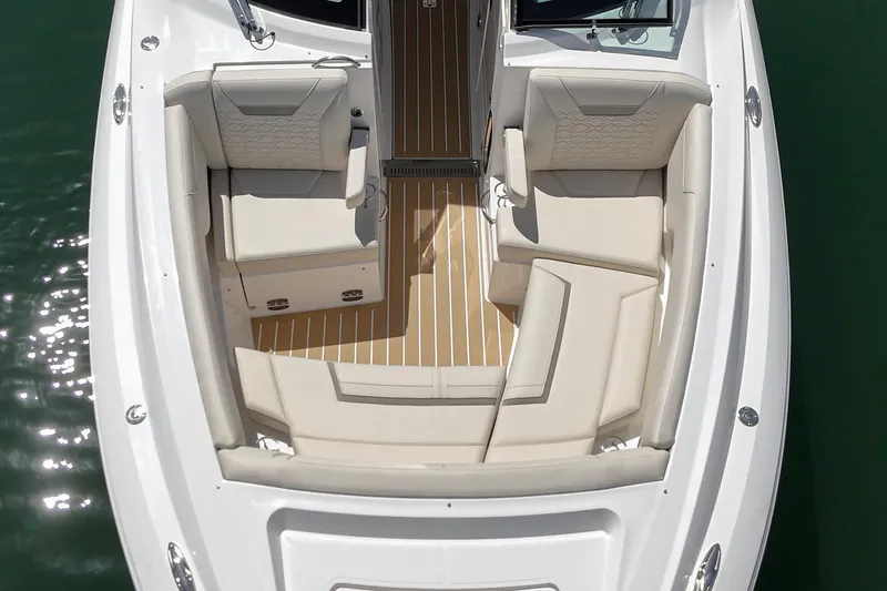 Slide: The Image of 2026 Tiara Yachts 34 LX boat interior with luxurious seating and elegant wood flooring. - 18