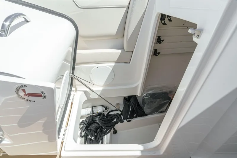 Slide: The Image of Storage compartment on 2026 Tiara Yachts 34 LX, featuring fire extinguisher and ropes. - 20