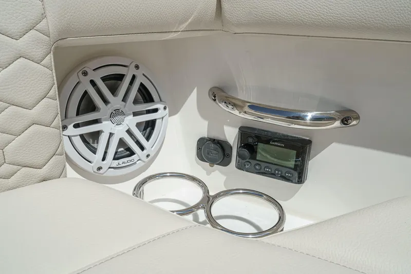 Slide: The Image of 2026 Tiara Yachts 34 LX interior with JL Audio speaker and Garmin control panel. - 21