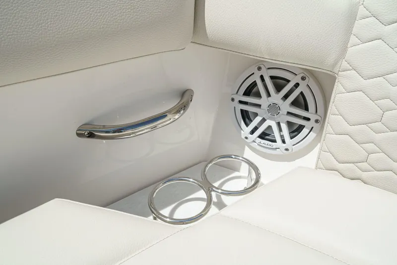 Slide: The Image of 2026 Tiara Yachts 34 LX interior with speaker, cup holders, and luxurious seating. - 22