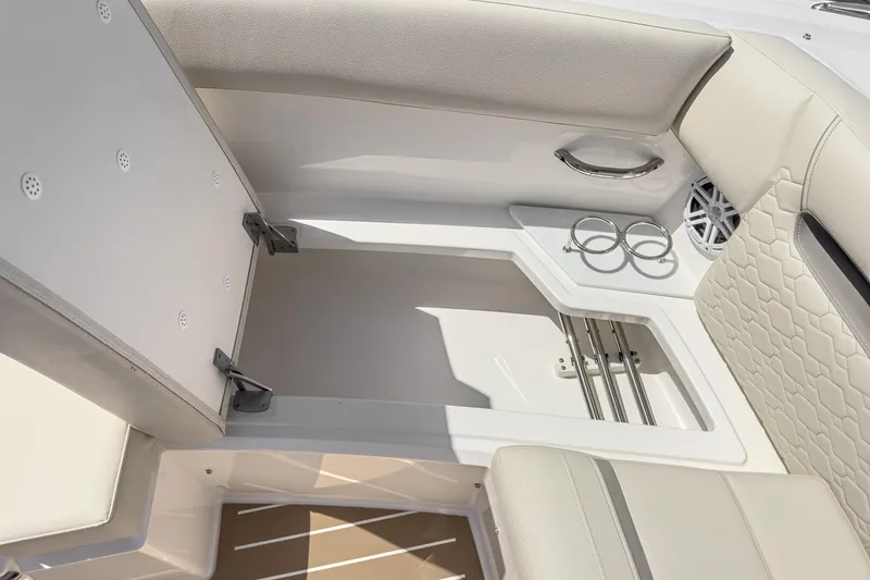 Slide: The Image of 2026 Tiara Yachts 34 LX interior with storage compartment and cup holders. - 23