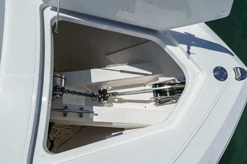 Slide: The Image of Anchor compartment of 2026 Tiara Yachts 34 LX, showcasing chain and winch system. - 24